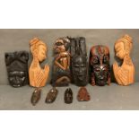 A selection of wall hanging tribal mask and carvings