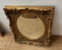 A gilt Gesso style square frame with oval mirror plate 80cm x 70cm