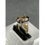 A smokey quartz and diamond ring, oval cut smoky quartz weighing on a 7.20ct claw set with a