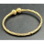 A 9ct gold, marked 375, flexible bangle with ball ends, approx total weight 5.8g