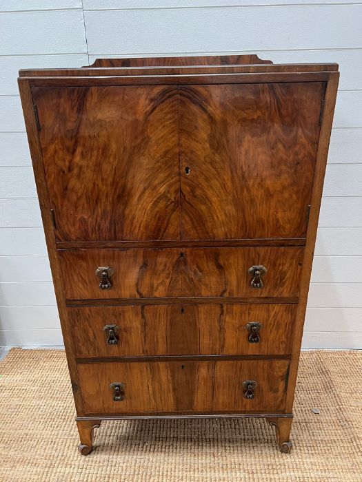 A walnut cabinet with cupboard and drawers below (H120cm W68cm D45cm)
