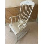 A painted Windsor style rocking chair with spindle back and sides