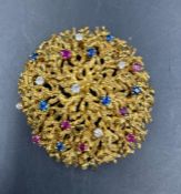 An 18ct gold brooch with sapphire, ruby and diamond decoration (Approximate Total weight 33g)
