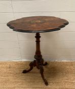 A burr walnut inlaid pedestal side table on carved central column ending in scrolling tripod legs (