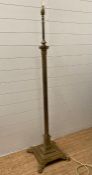 A brass Corinthian column floor standing lamp on a square base with lion paw feet