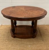 An oval centre table with four turned legs terminating on an oval plinth base (H77cm W110cm D73cm)