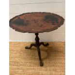 A George III style mahogany tripod table, fluted stem (H64cm W60cm D49cm)