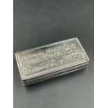 A silver pill box with embossed Last Supper motif.