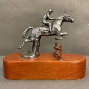 Horse Racing Interest: A mounted white metal figure of a jockey jumping possibly a bonnet