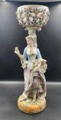 An 19th Century porcelain figural centrepiece depicting woman carrying flowers