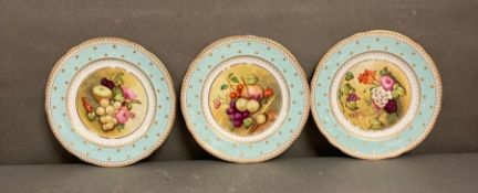 A set of three hand painted floral dinner plates