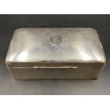 A silver engine turned cigarette box, top engraved with the letters R/K within a Cartouche,