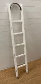 A white painted distressed vintage ladder