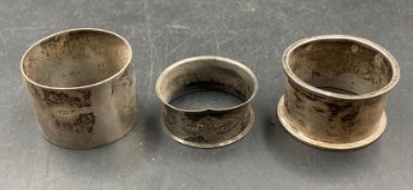 Three various silver napkin rings, various makers and hallmarks. (Approximate Total Weight 56g)