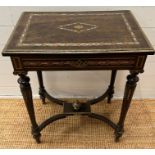 A French Napoleon III style ebonized and pearlized dressing table, hinged top on tapered legs joined