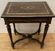 A French Napoleon III style ebonized and pearlized dressing table, hinged top on tapered legs joined