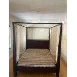 A contemporary wooden four poster bed with 5ft mattress