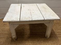 A painted white square table (H33cm W57cm D54cm)