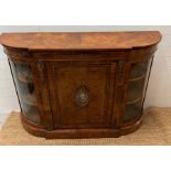 A Victorian inlaid Credenza of bow breakfront form with gilt metal edge, panelled door and centre