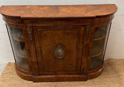 A Victorian inlaid Credenza of bow breakfront form with gilt metal edge, panelled door and centre