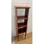 A faux painted and gilt three tier waterfall bookcase