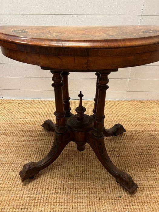 A Victorian card table, inlaid canted top on four turned supports and out swept legs with a turned - Image 5 of 7