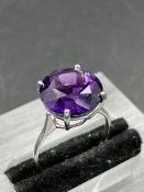 A single stone amethyst ring, round cut amethyst weighing an approximate 6.50ct, fourclaw set,