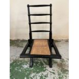 An Arts and Crafts style ebony folding chair