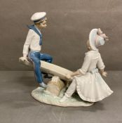 Seesaw. A boy and girl playing on a seesaw. Lladro. Designed by Vincente Martines. #1255. Marked “