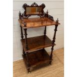 A Three tier rosewood whatnot with mirrored gallery to top, turned supports, castors (H125cm W60cm
