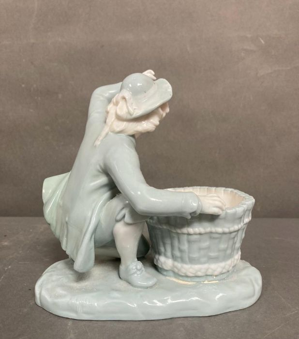 A late Victorian Mintons porcelain figure of a boy with a basket, marked to base - Image 2 of 4