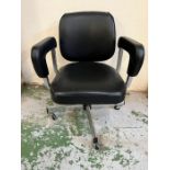 A vintage modernist style swivel office chair
