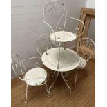 A wrought iron metal garden table and four chairs with scrolling design