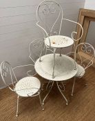 A wrought iron metal garden table and four chairs with scrolling design