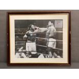 A Framed 16" x 20" signed photo by Muhammed Ali and Joe Frazier, along with a COA.