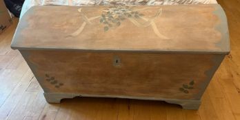 A domed wooden chest with wrought iron painted handles (H70cm W132cm D64cm)