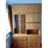 A large wall unit consisting of three drawers and two cupboards to base, a drink cabinet and two