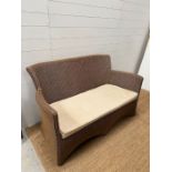 A rattan two seater sofa (H84cm W141cm D68cm SH40cm)