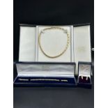 An 18ct (marked 750) yellow gold necklace, earring and bracelet (Approximate total weight 32.3g)