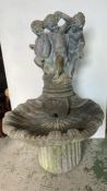 A reclaimed garden water fountain with cherubs sculpture to top coming down to shell base (H110cm