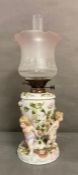 An 19th Century Sitzendorf figural oil lamp with cherub and floral motif H57cm