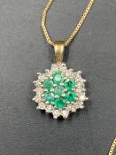 A emerald and diamond pendant on a fine 9ct gold chain. Approximate Total Weight 1.7g