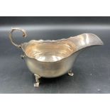 A silver sauce boat on three hoof feet, hallmarked for Chester, dated 1905 by Haseler Brothers