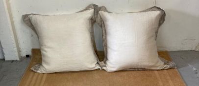 A pair of large beige linen cushions by Murielle Bolsseav