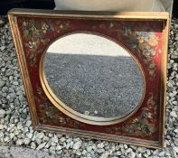 A small painted mirror with floral decorated to sides