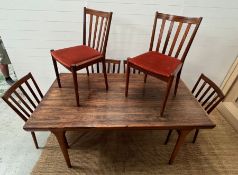 A Mid Century Scandinavian style extendable dining table with six matching chairs, attributed to