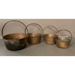 A graduated set of four brass jam pans