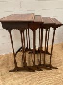 A mahogany nest of quartette, each table on spider legs. The table tops have beading and cross