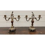 A pair of gilt bronze twin branch holders in rococo style with a painted body on square base, fitted