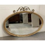 A wooden framed gold painted oval hall mirror 80cm x 105cm
